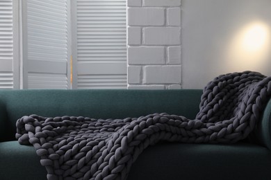 Soft chunky knit blanket on sofa in room