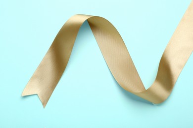 Beautiful ribbon on light blue background, top view