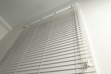 Photo of Window with closed blinds in room, low angle view