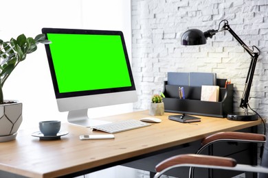 Image of Computer display with chroma key on desk in room. Comfortable workplace