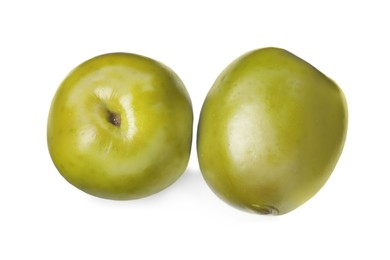 Two fresh green olives on white background, top view