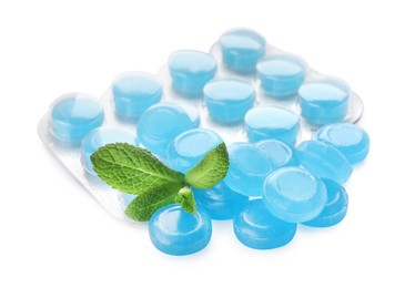 Many light blue cough drops with mint on white background