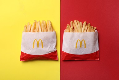 MYKOLAIV, UKRAINE - AUGUST 12, 2021: Two small portions of McDonald's French fries on color background, flat lay