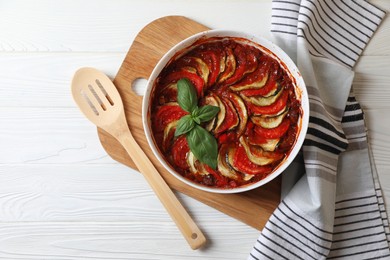 Photo of Delicious ratatouille on white wooden table, top view