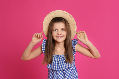 Portrait of preteen girl in hat on pink background