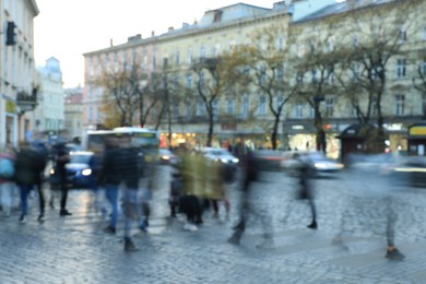 Photo of Blurred view of people crossing street in city