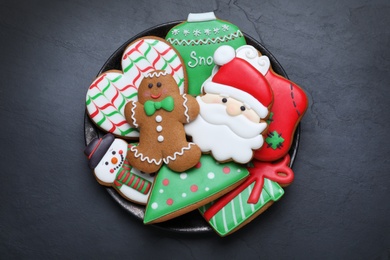 Delicious gingerbread Christmas cookies on black table, top view