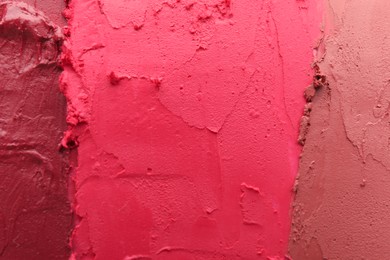 Texture of different lipsticks as background, closeup