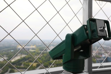 Photo of Green metal tower viewer on observation deck, closeup. Space for text