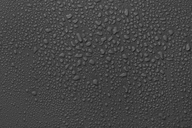 Photo of Many water drops on dark grey background
