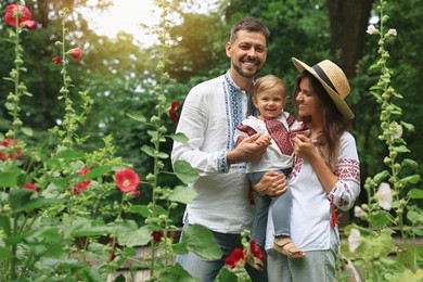Happy family in Ukrainian national clothes outdoors