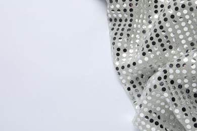 Photo of Shiny sequin fabric on white background, top view. Space for text