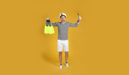 Excited sailor with swim fins and snorkel on white background