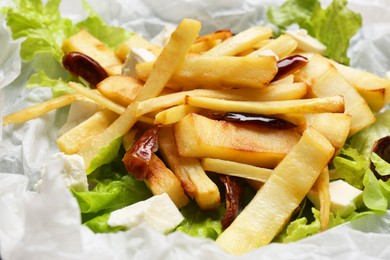 Photo of Delicious parsnip with lettuce, feta cheese and dates, closeup