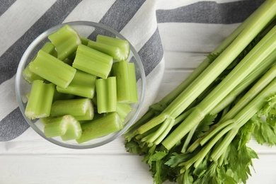 Fresh ripe green celery on white wooden table, flat lay