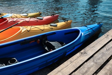 Modern kayaks with paddles on river. Summer camp activity