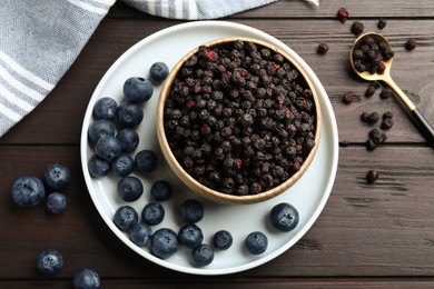 Freeze dried and fresh blueberries on wooden table, flat lay