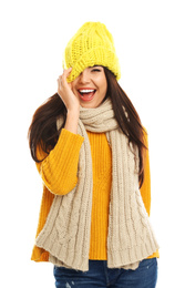 Happy young woman in warm clothes on white background. Winter vacation