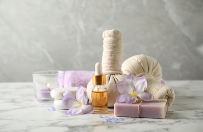 Spa composition with skin care products on white marble table