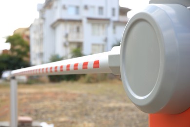 Photo of Closed automatic boom barrier on sunny day outdoors, closeup. Space for text