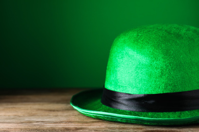 Green leprechaun hat on wooden table, closeup. St. Patrick's Day celebration