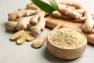 Dry and fresh ginger on light grey table, closeup