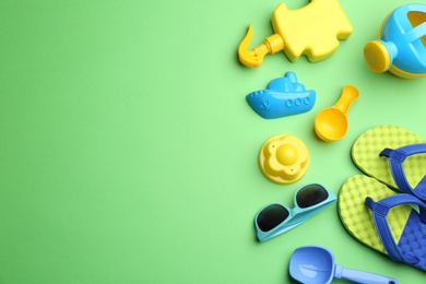 Flat lay composition with bright beach toys on color background. Space for text