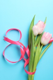 Photo of 8 March card design with tulips on light blue background, flat lay. International Women's Day