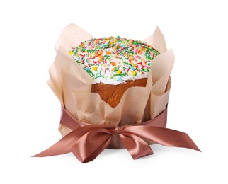Photo of Traditional Easter cake with sprinkles wrapped in parchment paper with ribbon isolated on white