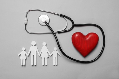 Photo of Paper family cutout, red heart and stethoscope on grey background, flat lay. Insurance concept