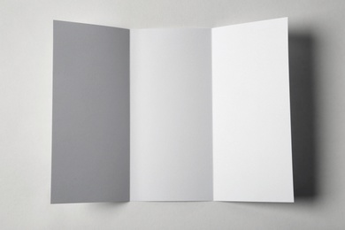 Blank brochure on white background, above view. Mock up for design