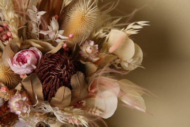 Beautiful elegant dried flower bouquet on beige background, closeup view