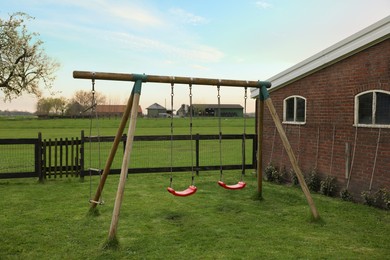 Spacious backyard with swing set in early morning