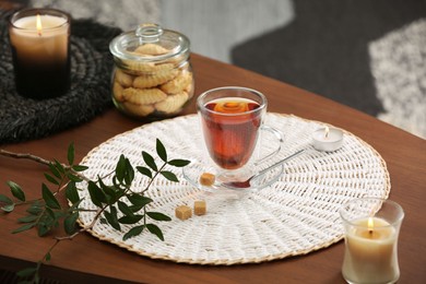 Tea, cookies and decorative elements on wooden table indoors