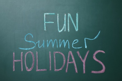 Text Fun Summer Holidays written on school chalkboard