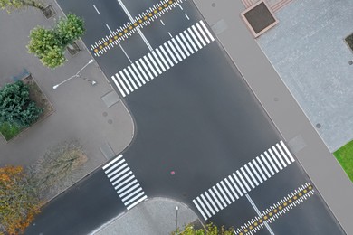 Aerial view of white pedestrian crossings on modern city street