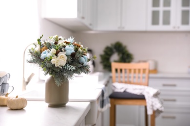 Beautiful winter bouquet on table in kitchen