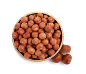 Bowl with tasty organic hazelnuts on white background, top view
