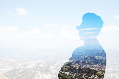 Double exposure of businessman and mountain landscape, space for text