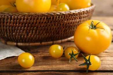 Ripe yellow tomatoes on wooden table, closeup