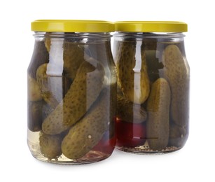 Jars of tasty pickled cucumbers isolated on white
