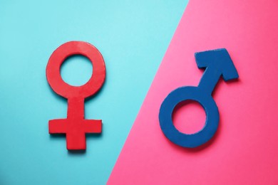 Gender equality. Male and female symbols on color background, flat lay