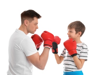 Dad and his son with boxing gloves on white background