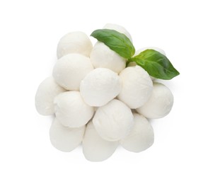 Pile of mozzarella cheese balls and basil on white background, top view