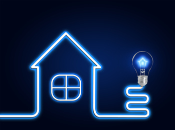 Creative image of house and light bulb on dark background. Energy efficiency, loan, property or business idea concepts