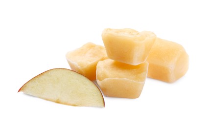 Frozen apple puree cubes and fruit on white background