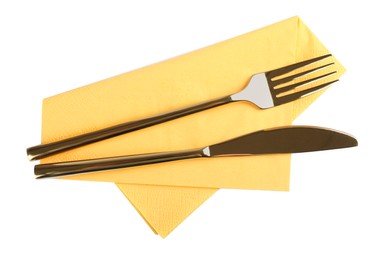 Yellow napkin with golden fork and knife on white background, top view