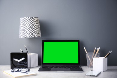 Image of Laptop display with chroma key. Comfortable workplace in room