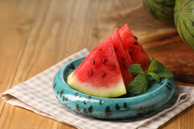 Photo of Slices of delicious ripe watermelon on wooden table, closeup