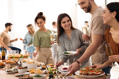 Group of people enjoying brunch buffet together indoors